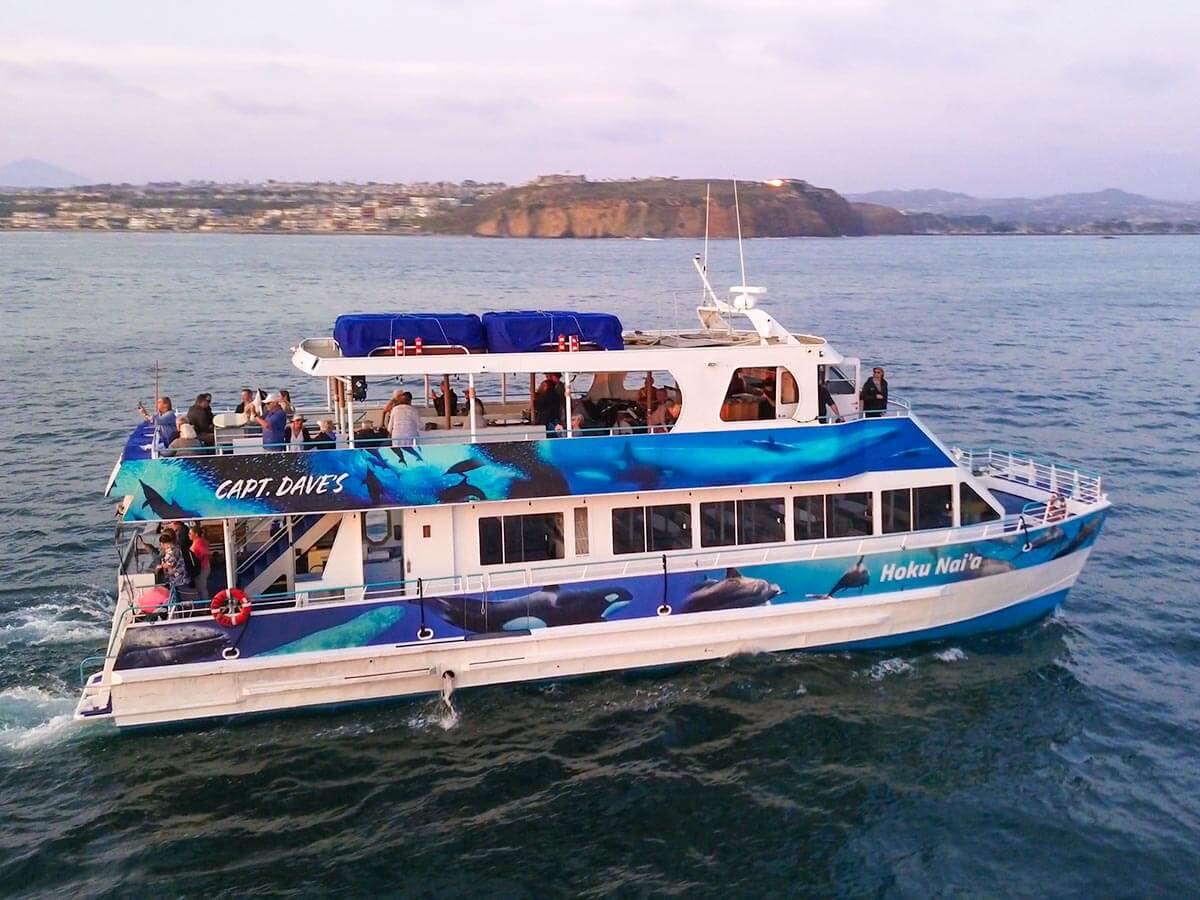 Hoku Nai'a, a power catamaran, in front of Dana Point Headlands at sunset